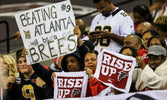 A New Orleans Saints fan trolls a bunch of Atlanta Falcons with a playful sign.