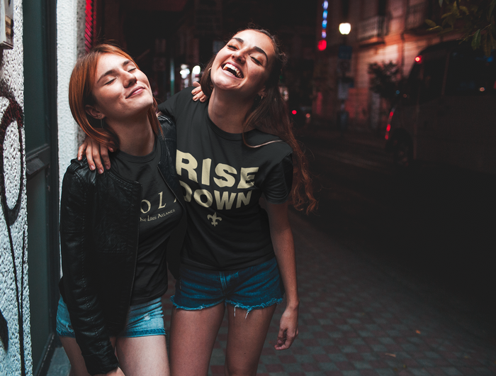 2 Beautiful New Orleans Saints fans wearing NOLA No One Likes Atlanta shirts celebrate in the French Quarter after the NO Saints beat the Atlanta Falcons.